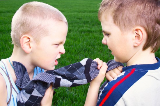 Children fighting over a sweater